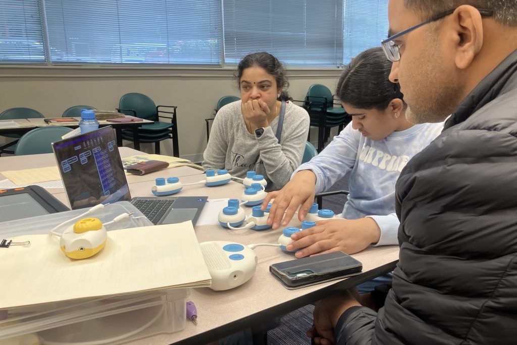 Mother and Father with their child working with the Code Jumper