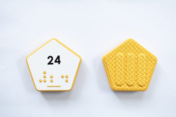 Front and back of yellow hexagonal Reach & Match Number tile showing the number 24 in Nemeth braille and print. The back side is textured.