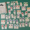 An overview of every piece that is included in the Memory Puzzles: Shape kit laid out on a teal background with their carrying case in the top left corner.