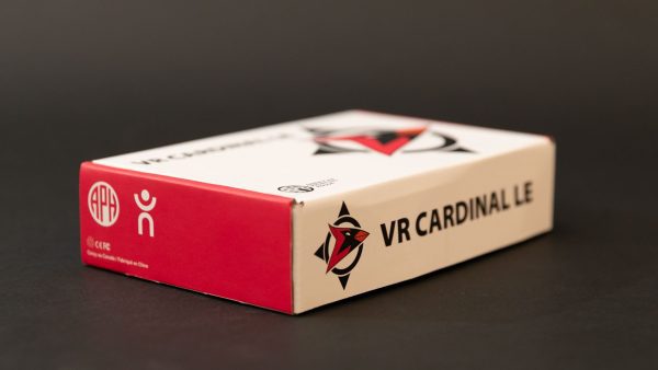 Side view of the VR Cardinal box. On the long edge is printed the the Cardinal logo, a compass-style graphic with a cardinal illustration with its beak pointing East, and the product name “VR CARDINAL LE.” On the short side are logos for APH and our partner HumanWare.