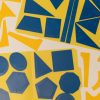 An overhead shot of the Geometric Drawing Stencils attached to a yellow folder with the 3D printed function stencils spread around them.
