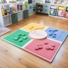 Reach and Match Light assembled on a wooden floor with the textured side up. On each square are tiles of the corresponding color.
