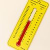 The Nemeth version of Tactile Demonstration Thermometer tilted 45 degrees on a white background. The thermometer is yellow with black labels and a red velvet temperature gauge that can be moved up and down using a clear tab that indicates the temperature. Fahrenheit is on the left, and Celsius is on the right. In the bottom right corner is a label that reads, "Nemeth."