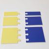 A variety of yellow and blue subunits laying face down in two rows. Both colors include subunits that have between one and three notches/connection points.