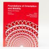 Foundations of Orientation and Mobility, Volume I: History and Theory, 4th edition sitting against a white background. The bottom half of the red cover features a geometric graphic.