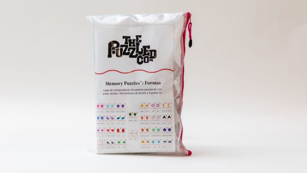 The Memory Puzzles: Shapes (Spanish) carrying pouch standing up on a white background. The front label contains drawings of all the shapes contained in the set.