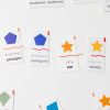 Two pairs of Memory Puzzles: Shapes with one English piece and one Spanish piece (pentagons and stars).