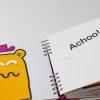 An open page of My Nose with the character illustration on the left with their eyes closed. On the right page is large print and braille that reads "Achoo!" 