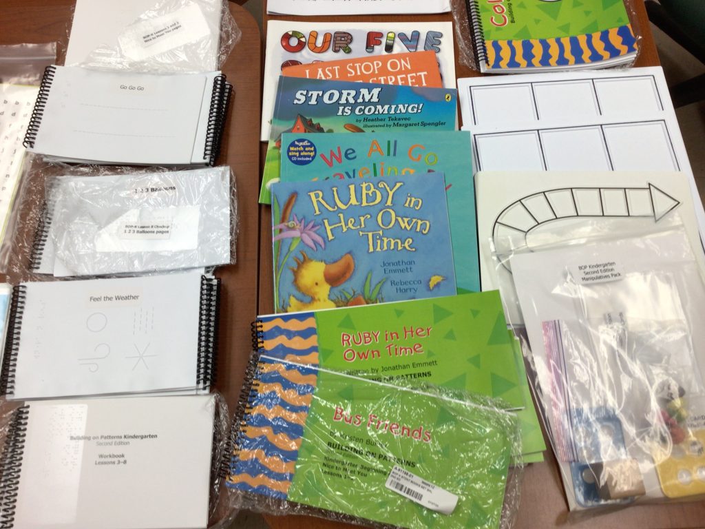 Copies of childrens books lay in a row, next to activity sheets.