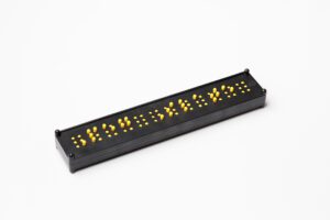 The black and yellow Peg Slate placed on a white background