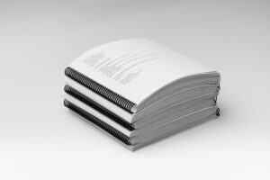 A stack of all the volumes included in the BOP 2nd Grade Unit 6 Braille Teacher's Kit.